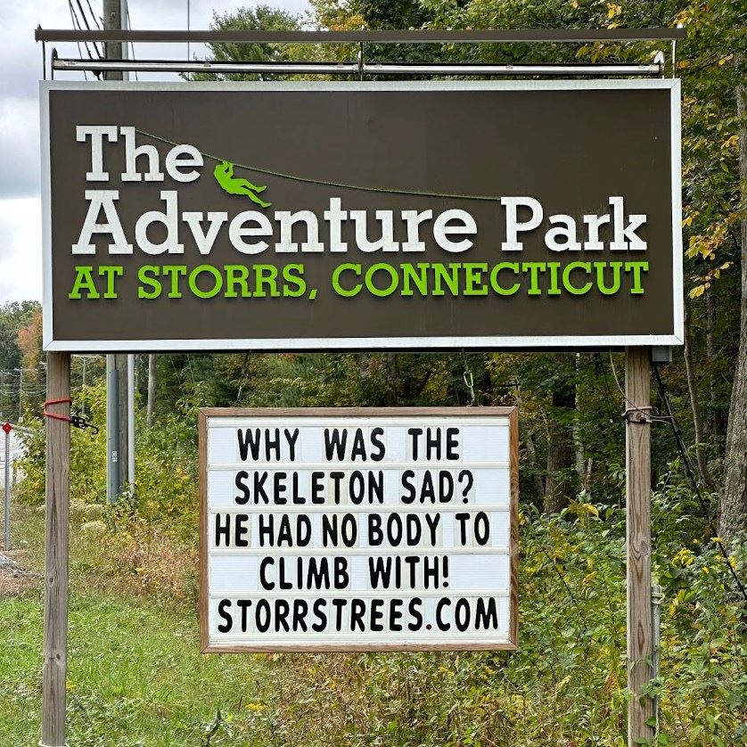 Roadside sign promoting The Adventure Park at Storrs with a humourous message