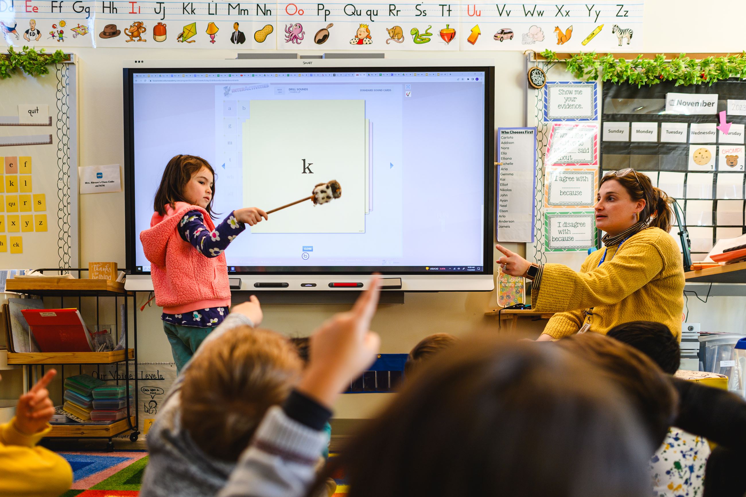 Girl with wand writing letters in the air